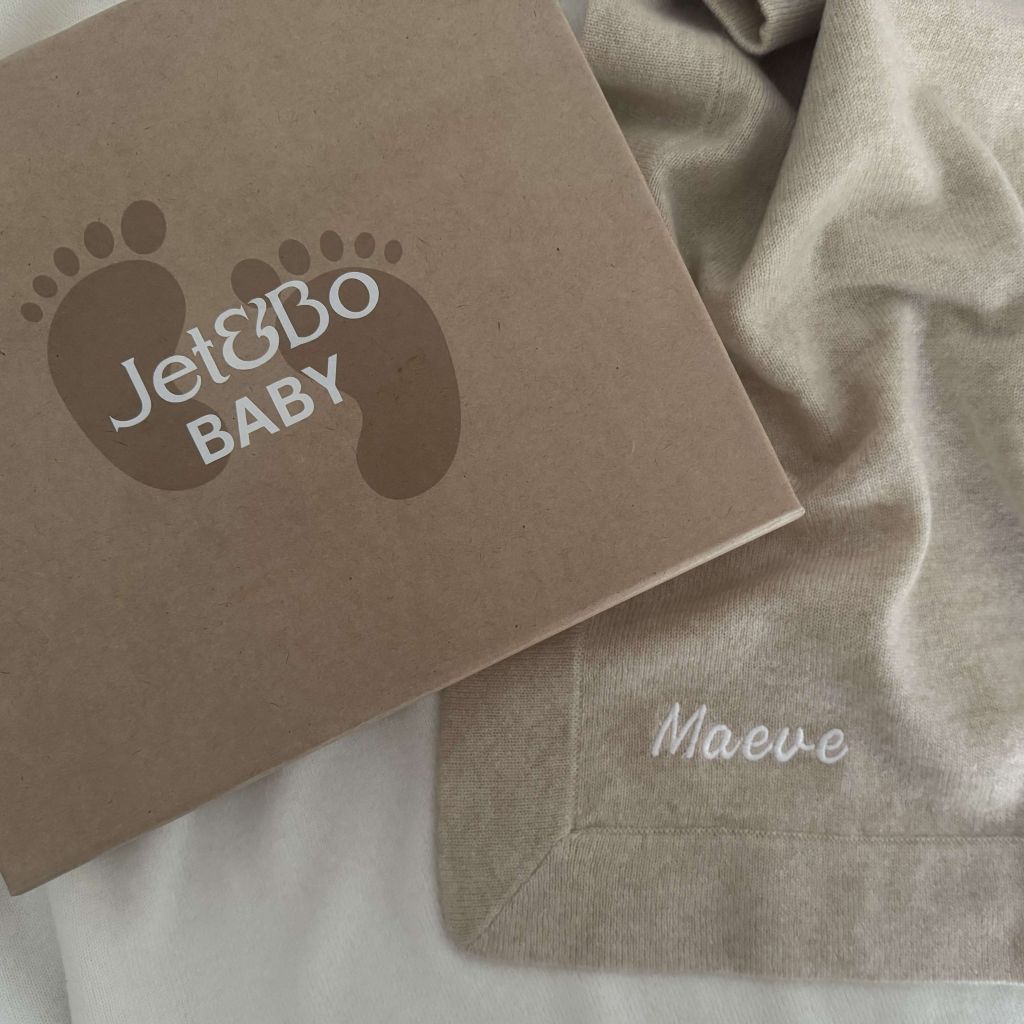Personalized cashmere baby blanket with the name Maeve and gift box